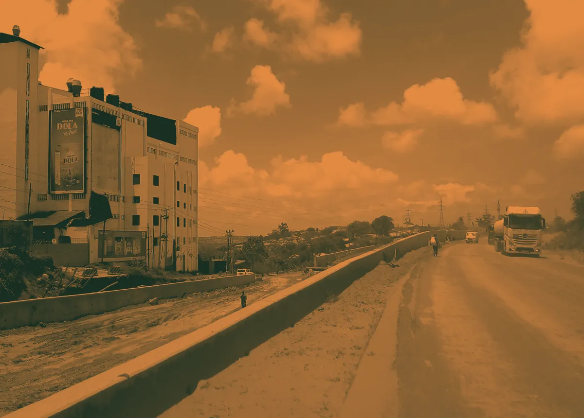 A highway under construction, with heavy vehicles on a new carriageway.